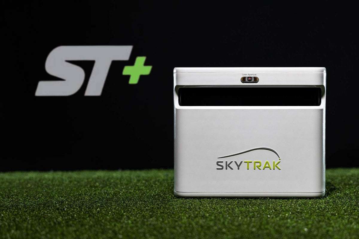 ST+ text next to a SKYTRAK launch monitor on turf black background