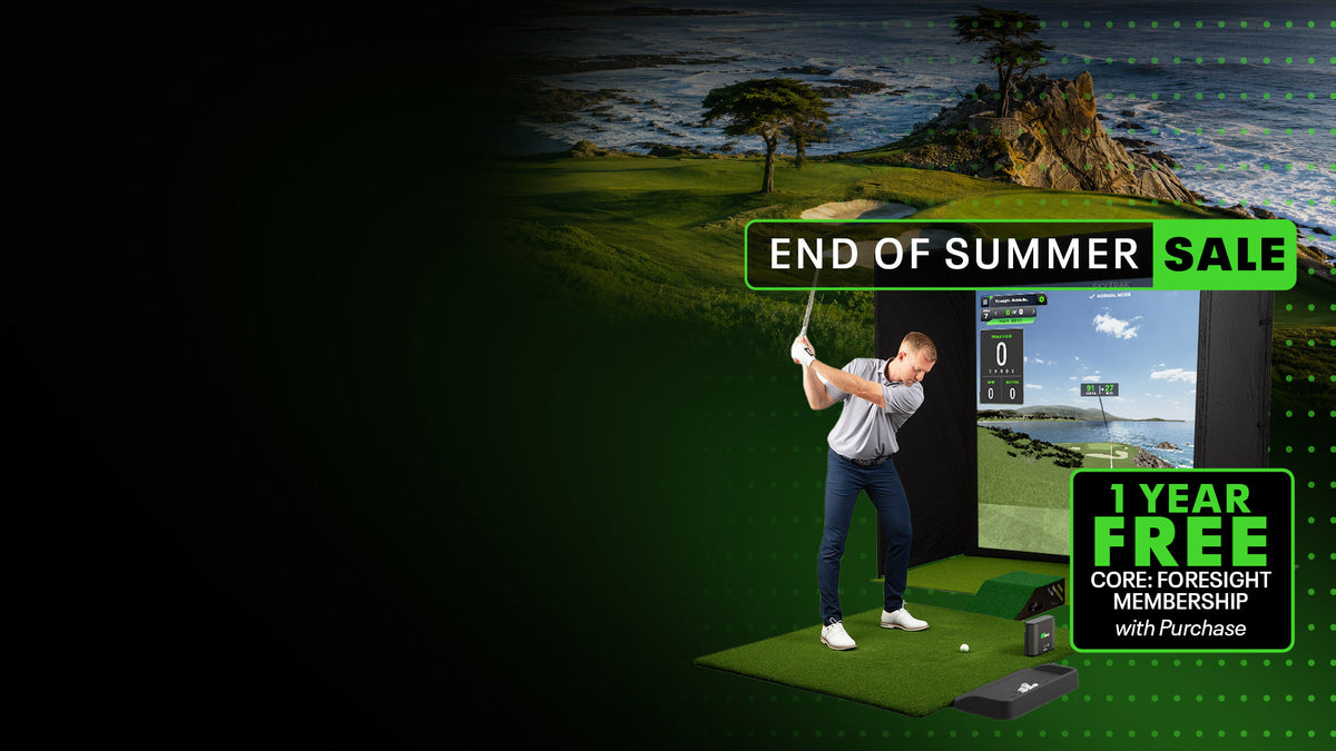 A man in a golf simulator wearing a white shirt and blue jeans, swinging a golf club in front of a coastal golf course backdrop. Promotional text overlays read 'END OF SUMMER SALE' and '1 YEAR FREE CORE-FORESIGHT MEMBERSHIP with Purchase'.

