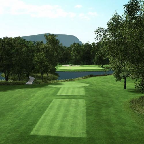 Golf Club de Geneve course with green grass, trees, and a body of water under a clear sky.