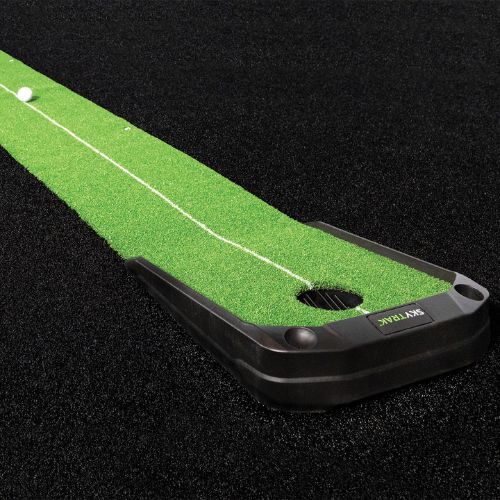 Golf return putting green with a ball on a black background