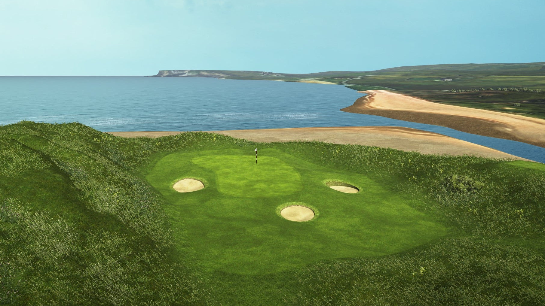 Golf course with a green and sand bunkers overlooking a body of water.
